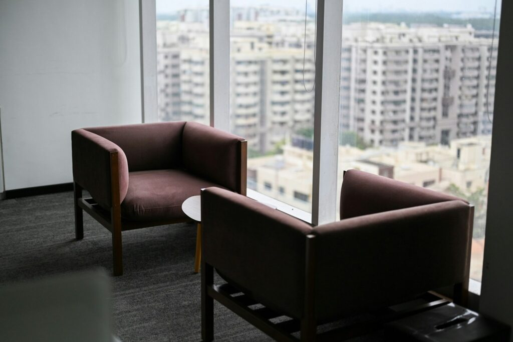 Two armchairs and a low table beside a window