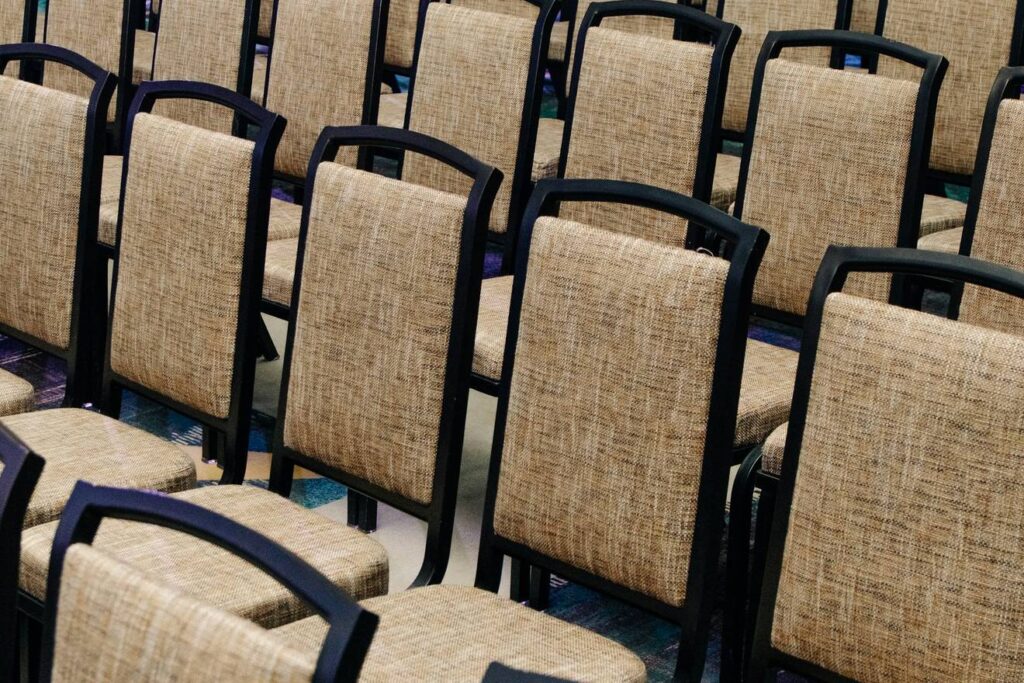 Rows of empty upholstered auditorium seats