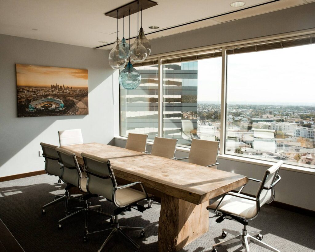 Boardroom with a timber table and chairs beside a window